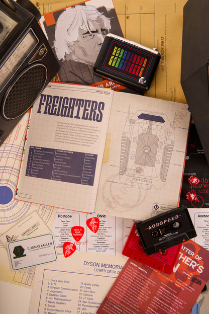 Double page spread showing "Freighters" from Afterburn surrounded by cassettes and other various items